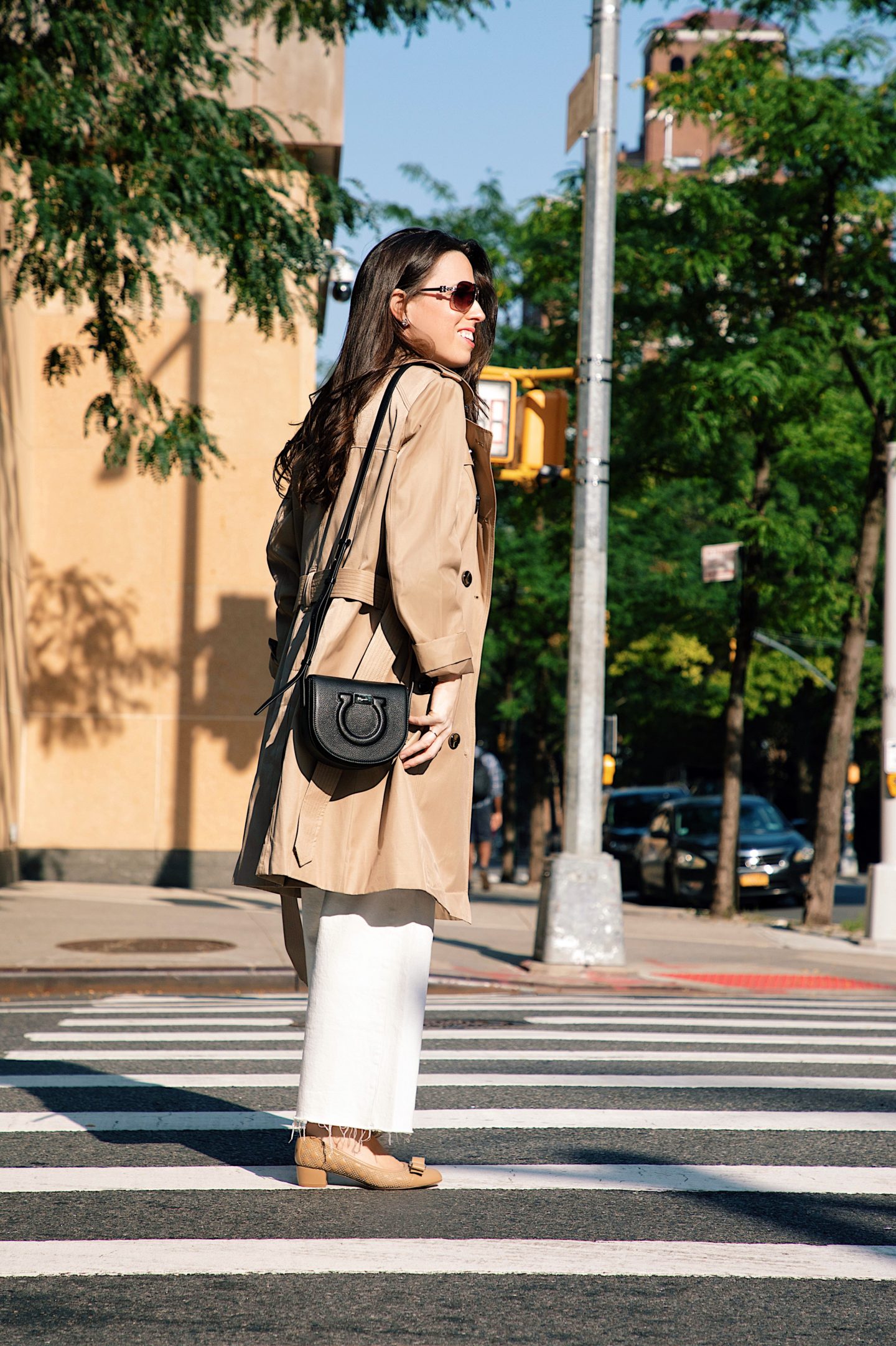 Ana Florentina wearing London Fog Trench Coat with white jeans a black top